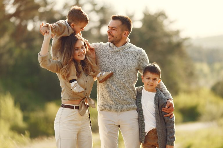 cute family playing in a summer field