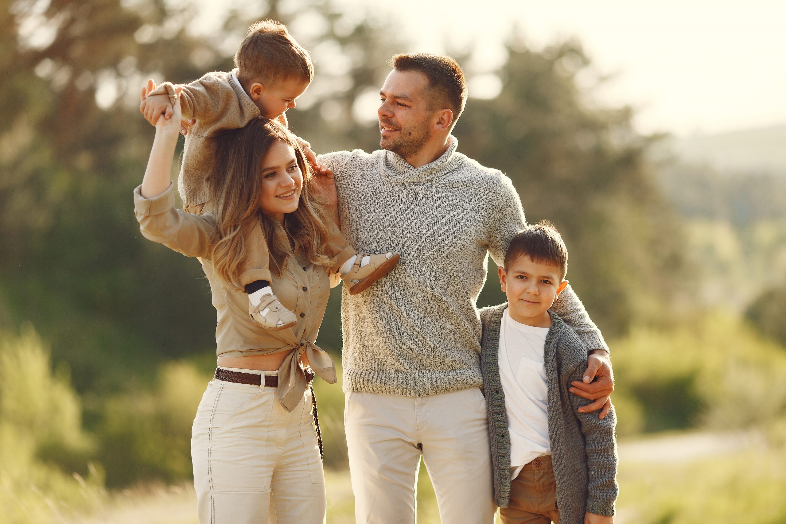 cute family playing in a summer field